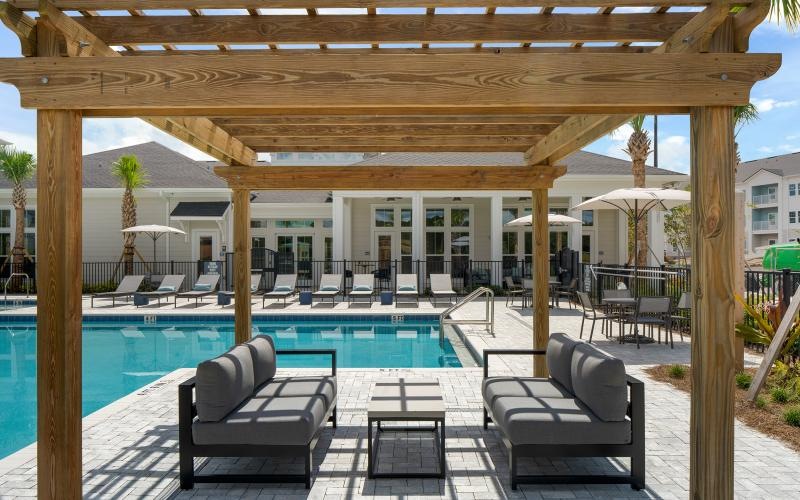 a pool with chairs and a deck